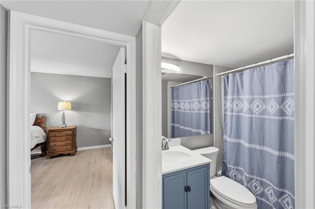 Bathroom featuring a modern vanity with a white countertop and a brushed nickel faucet