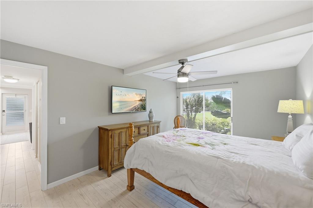 Neutral wall paint, light wood-finish flooring, and a ceiling fan with integrated lighting