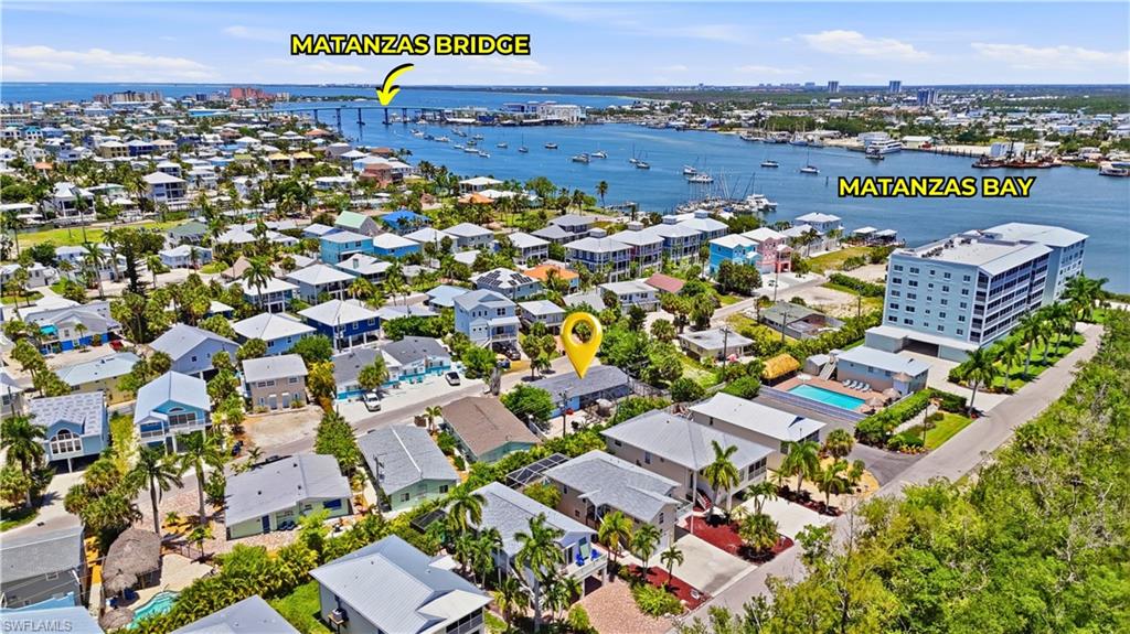 Aerial perspective showcasing the property within a coastal community, featuring proximity to Matanzas Bay and the Matanzas Bridge - Virtually Edited Image