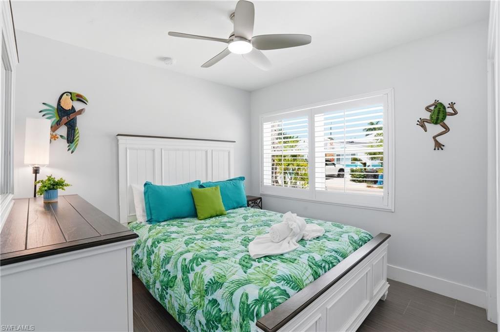 Bedroom featuring a white paneled bed frame and matching dresser - Virtually Edited Image