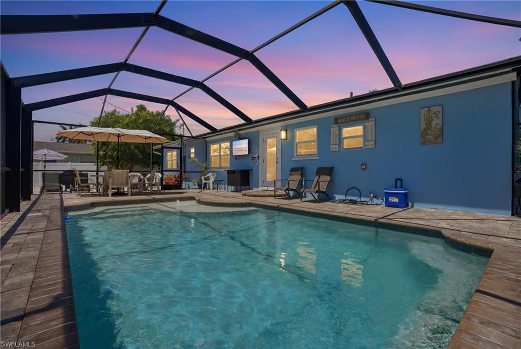 Screen-enclosed swimming pool with a paved deck - Virtually Edited Image