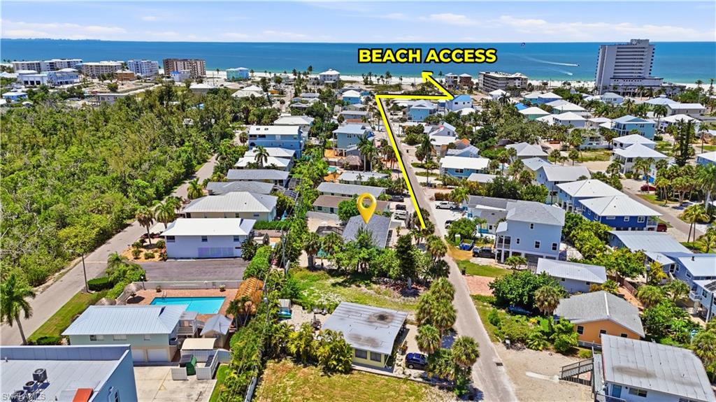 Aerial perspective showcasing the property's proximity to the coastline, with a clear path to beach access - Virtually Edited Image