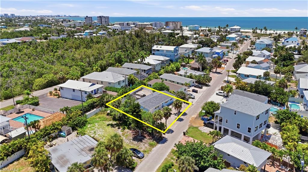 Coastal community setting featuring a single-story residence with mature palm trees - Virtually Edited Image