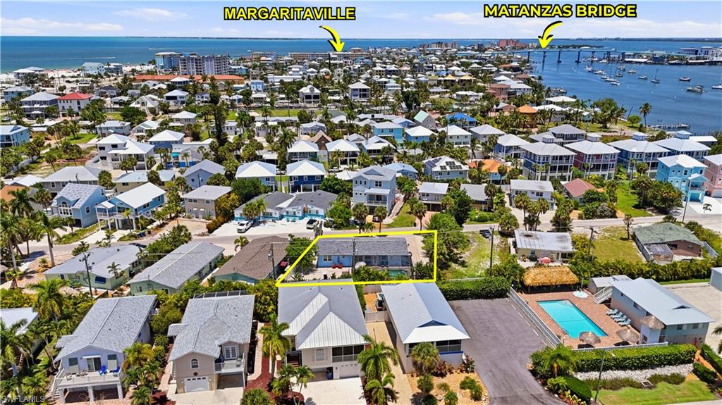 Aerial perspective showcasing a coastal community with numerous residences - Virtually Edited Image
