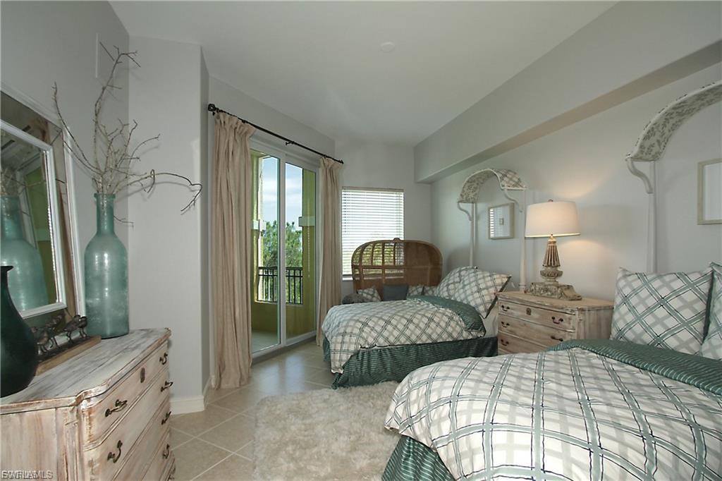 Bedroom with access to exterior and light tile patterned floors
