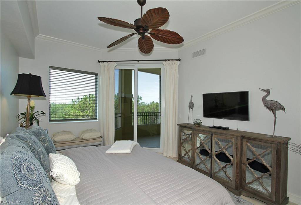 Bedroom with ceiling fan, ornamental molding, and access to exterior