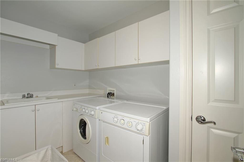 Laundry area featuring cabinet space and washer and dryer