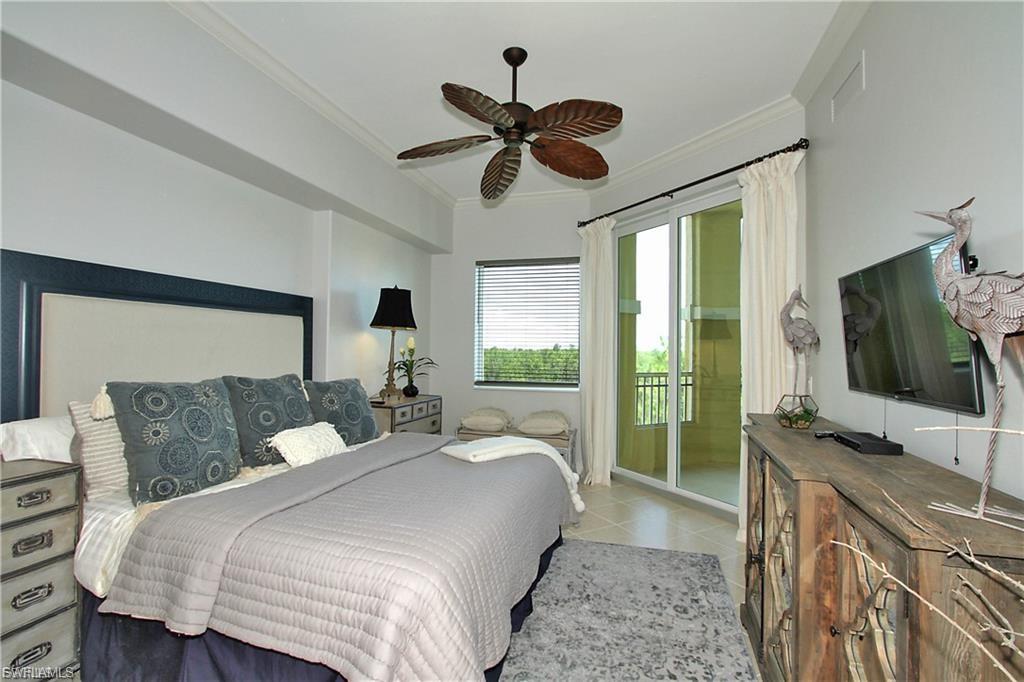 Bedroom with ornamental molding, ceiling fan, and access to outside