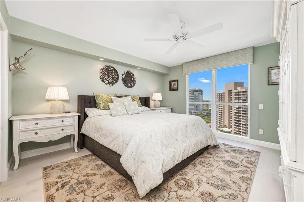 Bedroom featuring a city view, a ceiling fan, and baseboards