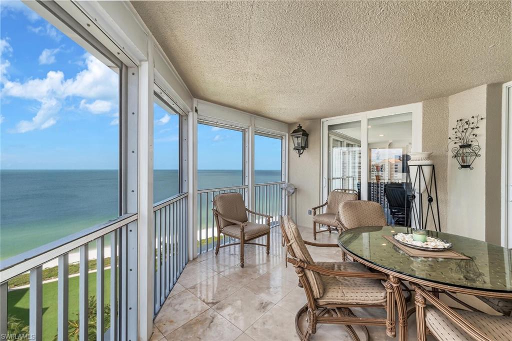 Sunroom featuring a water view