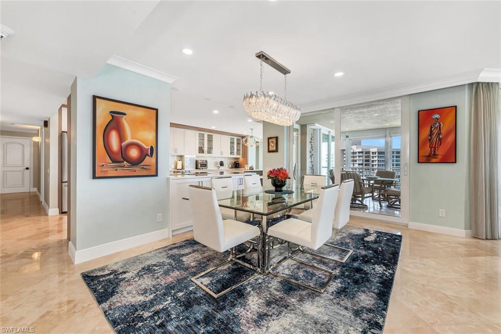 Dining space featuring baseboards, crown molding, a chandelier, and recessed lighting