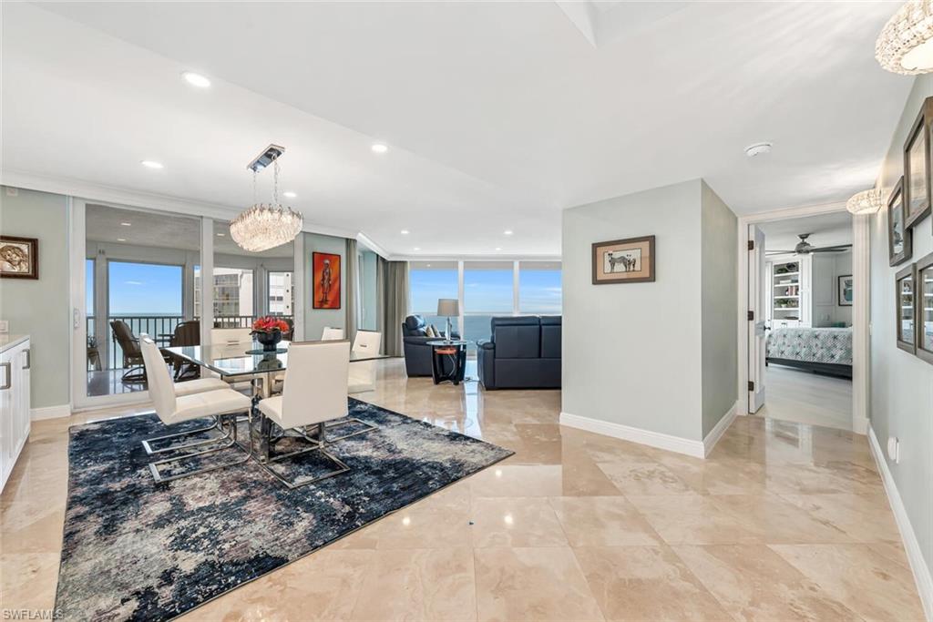 Dining space featuring marble finish floor, baseboards, and ornamental molding