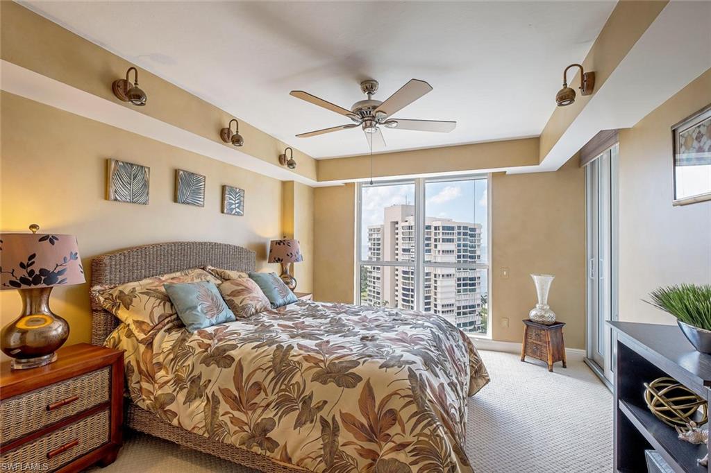 Carpeted bedroom featuring ceiling fan, baseboards, and access to outside