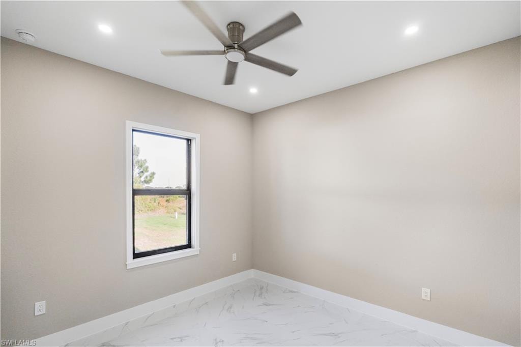 Spare room featuring a ceiling fan, light marble finish floors, recessed lighting, and a smoke detector