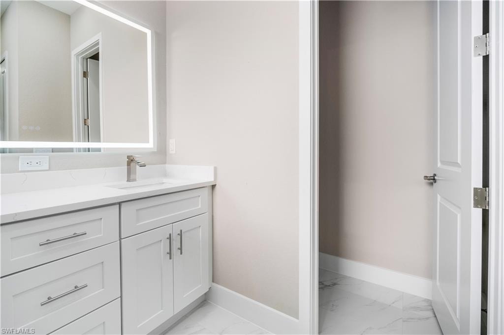 Bathroom with vanity and baseboards