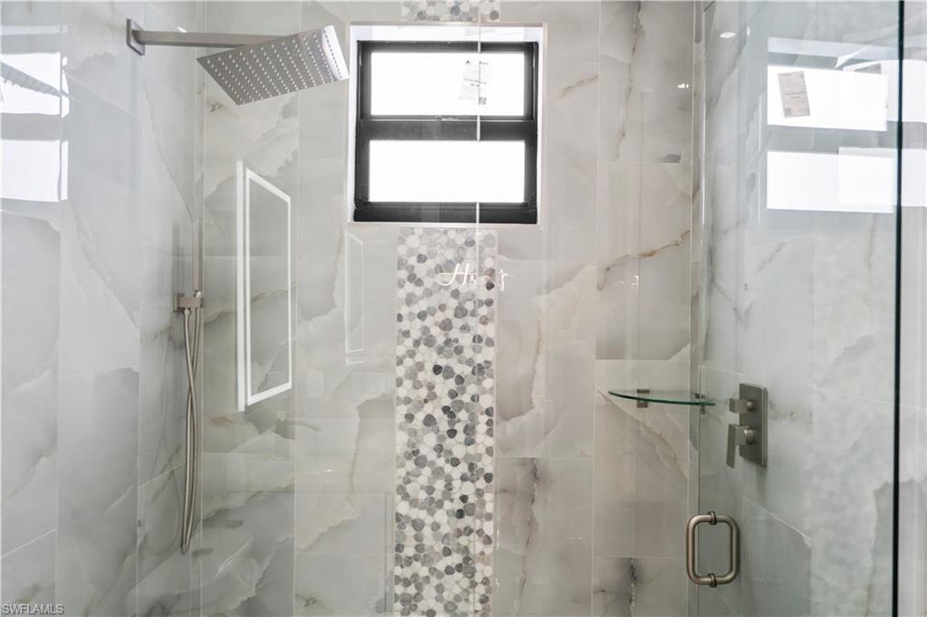 Full bath featuring a marble finish shower