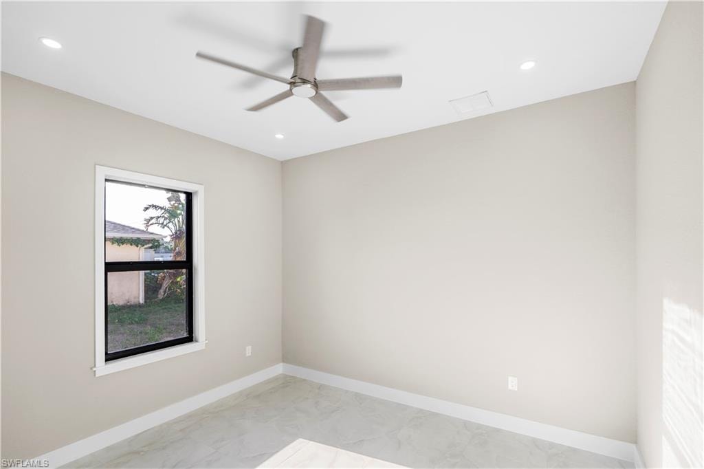 Spare room featuring ceiling fan, recessed lighting, and light marble finish floors