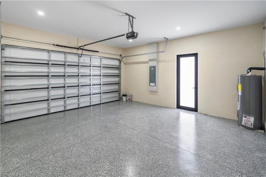 Garage with water heater and electric panel