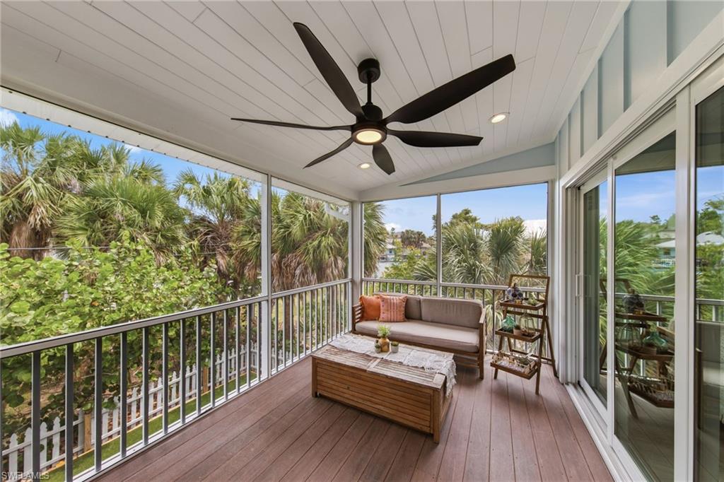 Screened Porch featuring outdoor seating, a ceiling fan, and a deck