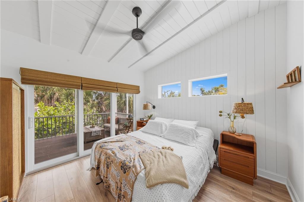 Bedroom featuring access to outside, light wood-style flooring, lofted ceiling, and ceiling fan