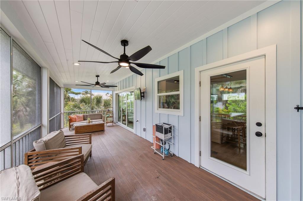 Screened Porch featuring outdoor seating, a ceiling fan, and a deck