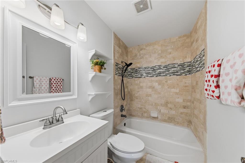 Bathroom with vanity and shower / bath combination