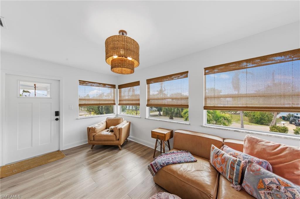Living area featuring light wood-style flooring and baseboards