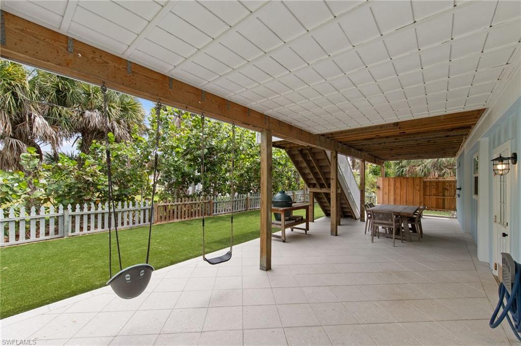 Fenced backyard featuring outdoor dining space and a patio