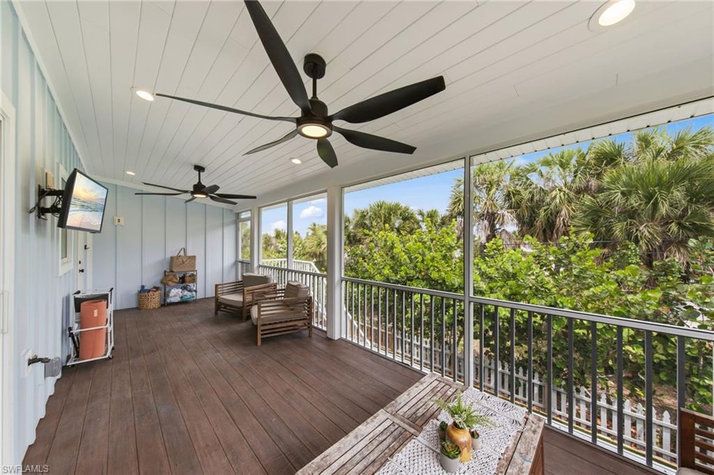Screened Porch featuring outdoor seating, a ceiling fan, and a deck
