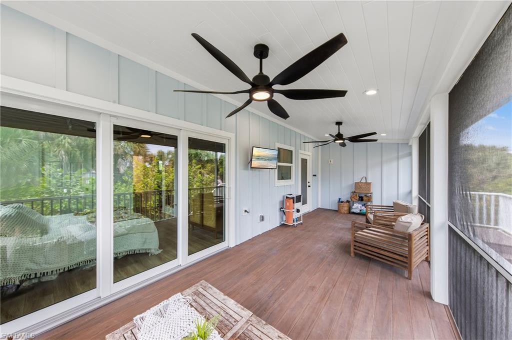 Screened Porch featuring outdoor seating, a ceiling fan, and a deck