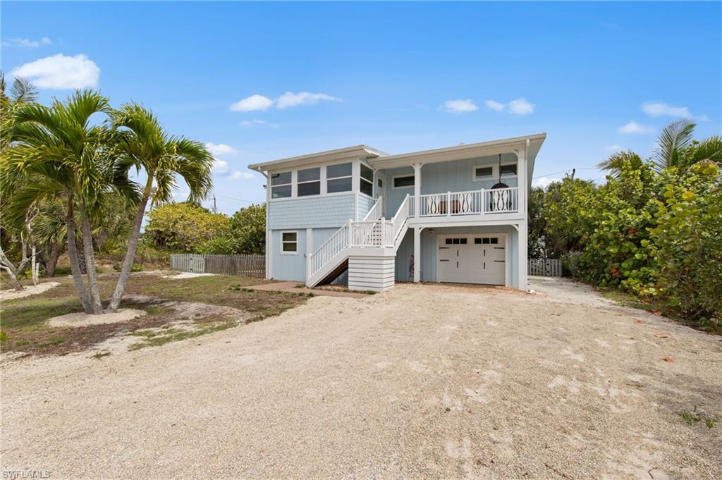 Coastal home with driveway and a garage