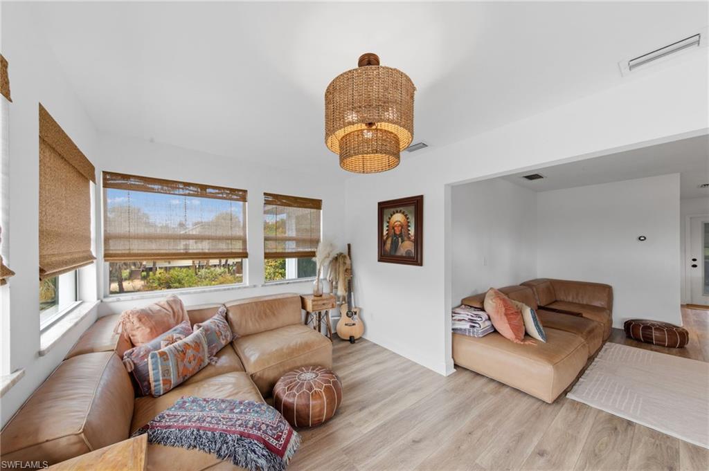 Living area featuring light wood-type flooring and hanging lights