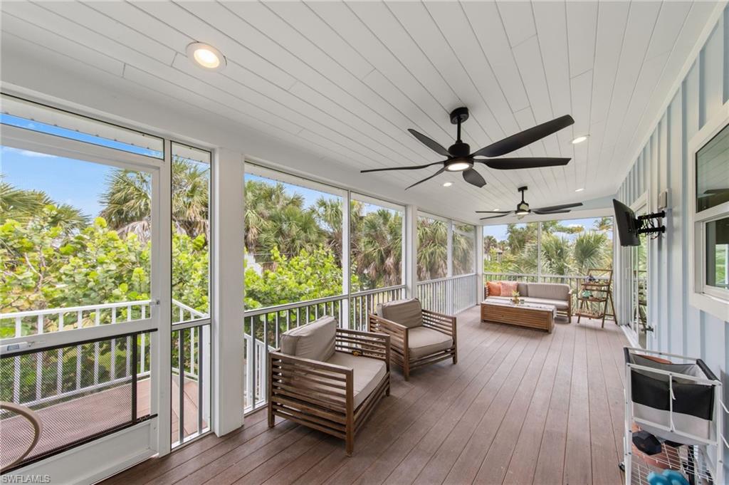 Screened Porch featuring outdoor seating, a ceiling fan, and a deck