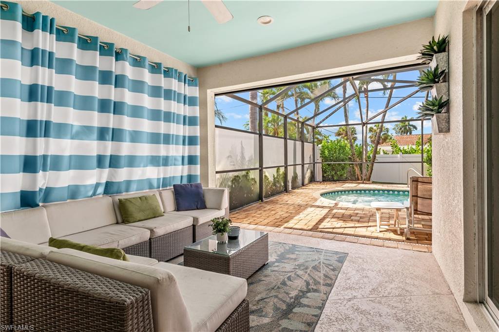 Open-concept living area featuring a decorative accent wall, recessed lighting, and a modern ceiling fan