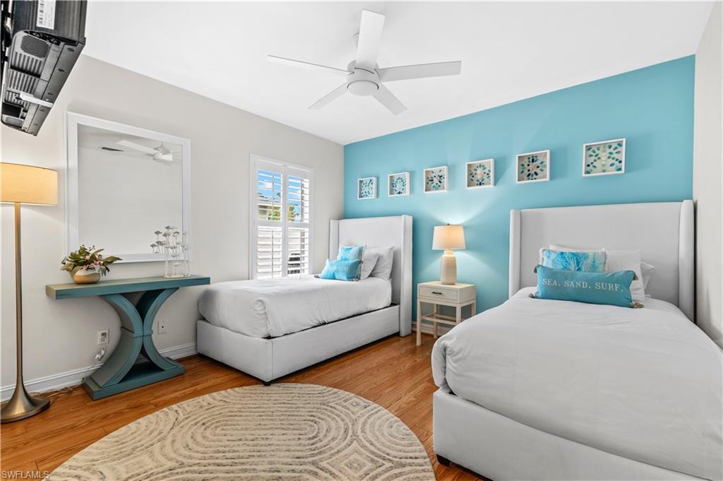 Entryway and office area in living room featuring a white four-panel door, tray ceiling, and neutral tile flooring