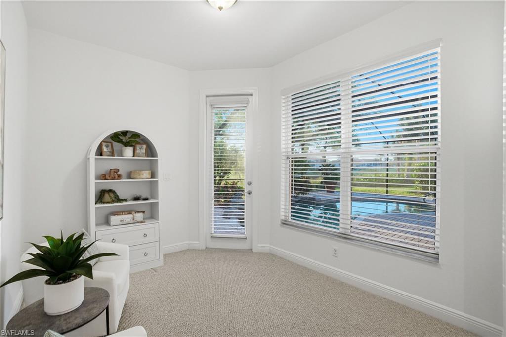 Situated just off the primary bedroom with a bright sunrise  view of the pool and a private full light glass door leading out to the expanded pool lanai.