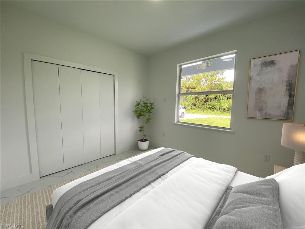 Bedroom featuring a closet. Photos are of a staged model or similar plan. Features and finishes may vary.