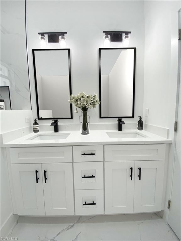 Full bathroom with double vanity and light marble finish flooring. Photos are of a staged model or similar plan. Features and finishes may vary.