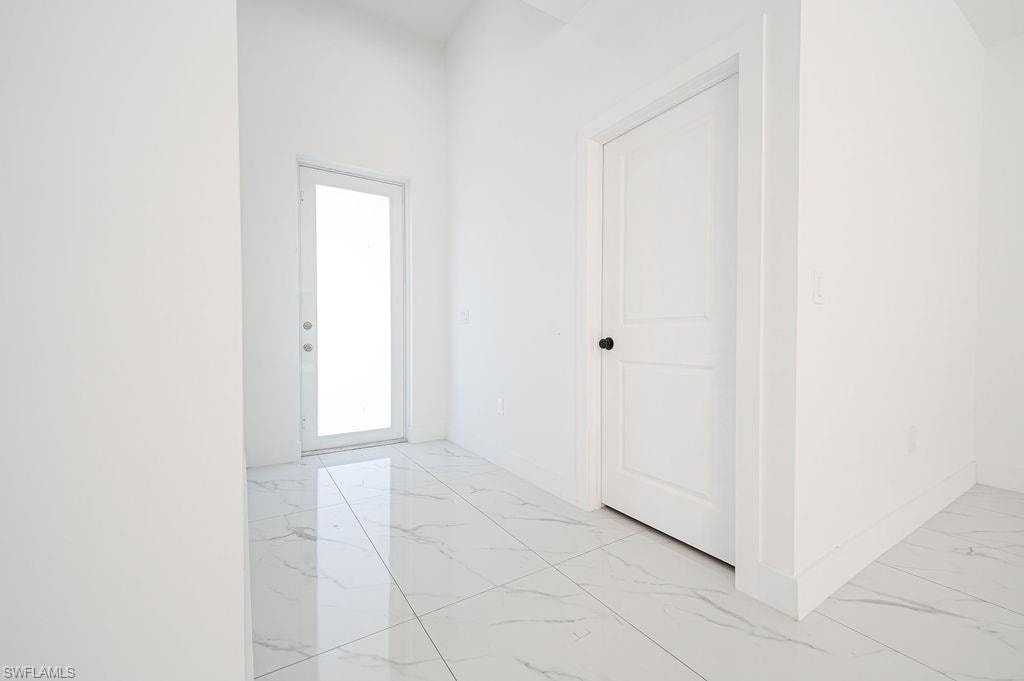 Foyer entrance with light marble finish flooring. Photos are of a staged model or similar plan. Features and finishes may vary.