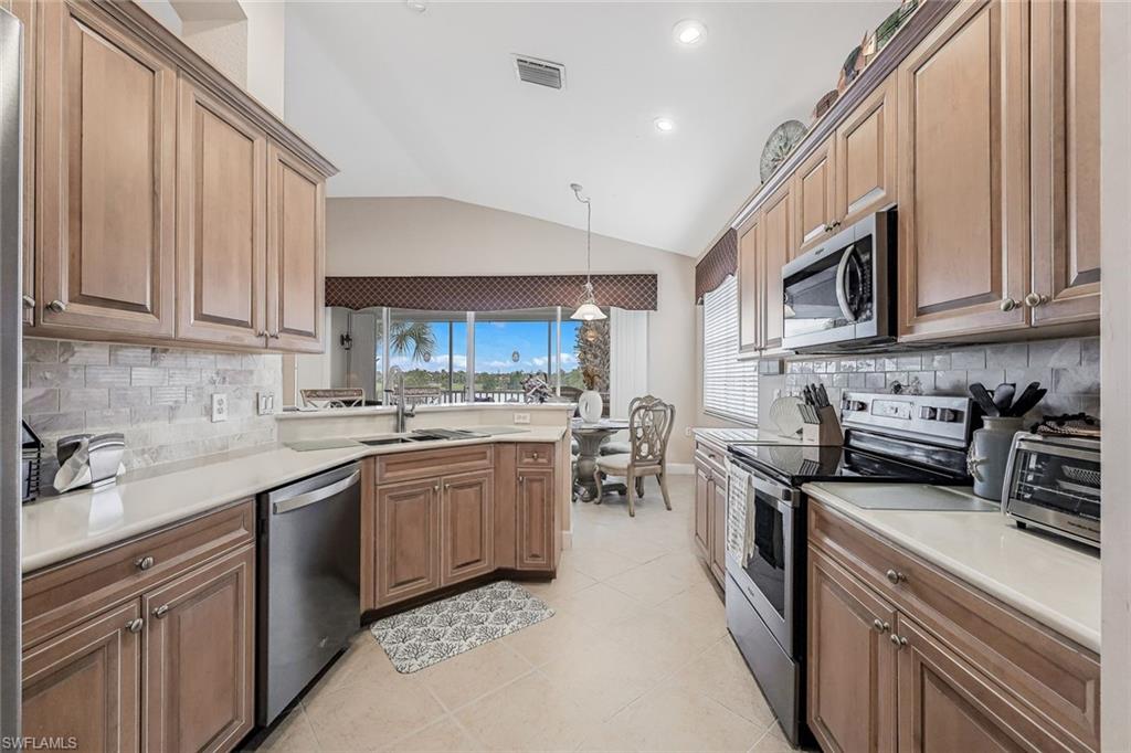 Travertine backsplash, plenty of counters for food prep...and from the sink a great lakeview!