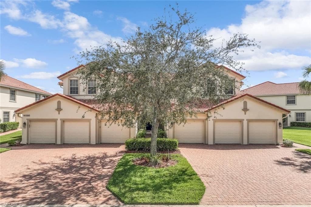 Center entry serving upper units, pavered driveways Single Car Attached Garage