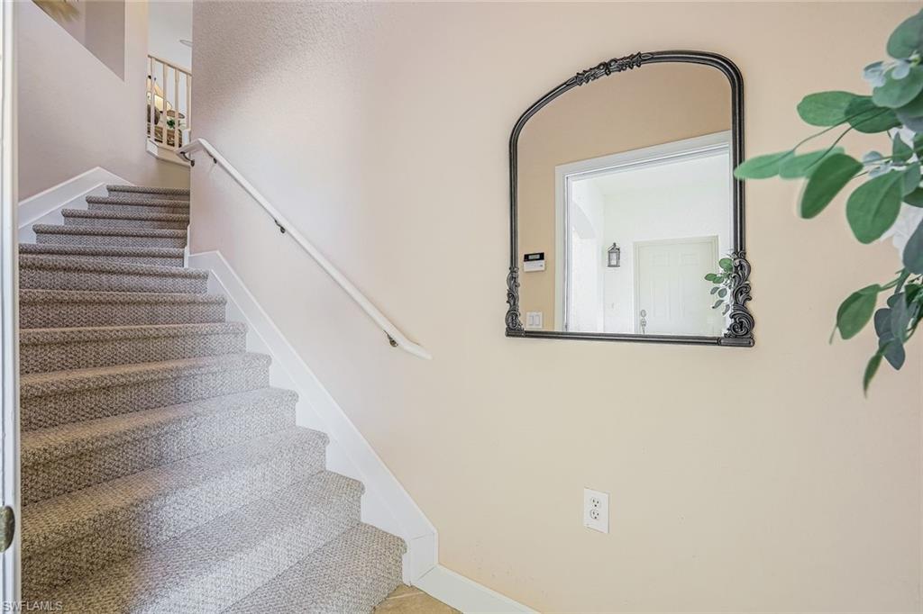 Interior entry at ground level with wide stairway and decorative niche