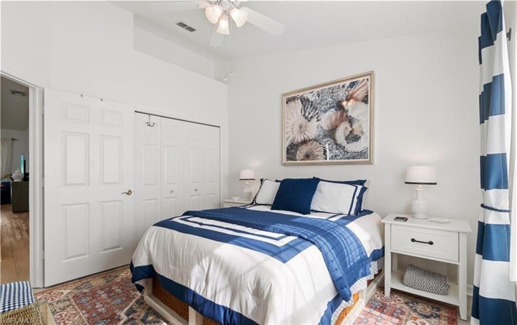 Bedroom with a closet, lofted ceiling, ceiling fan, and visible vents
