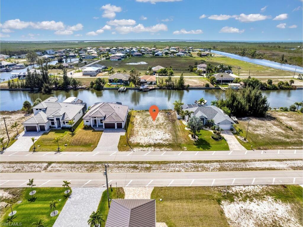 Aerial view of residential area featuring a nearby body of water