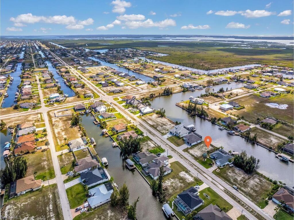 Aerial overview of property's location featuring nearby suburban area and a nearby body of water