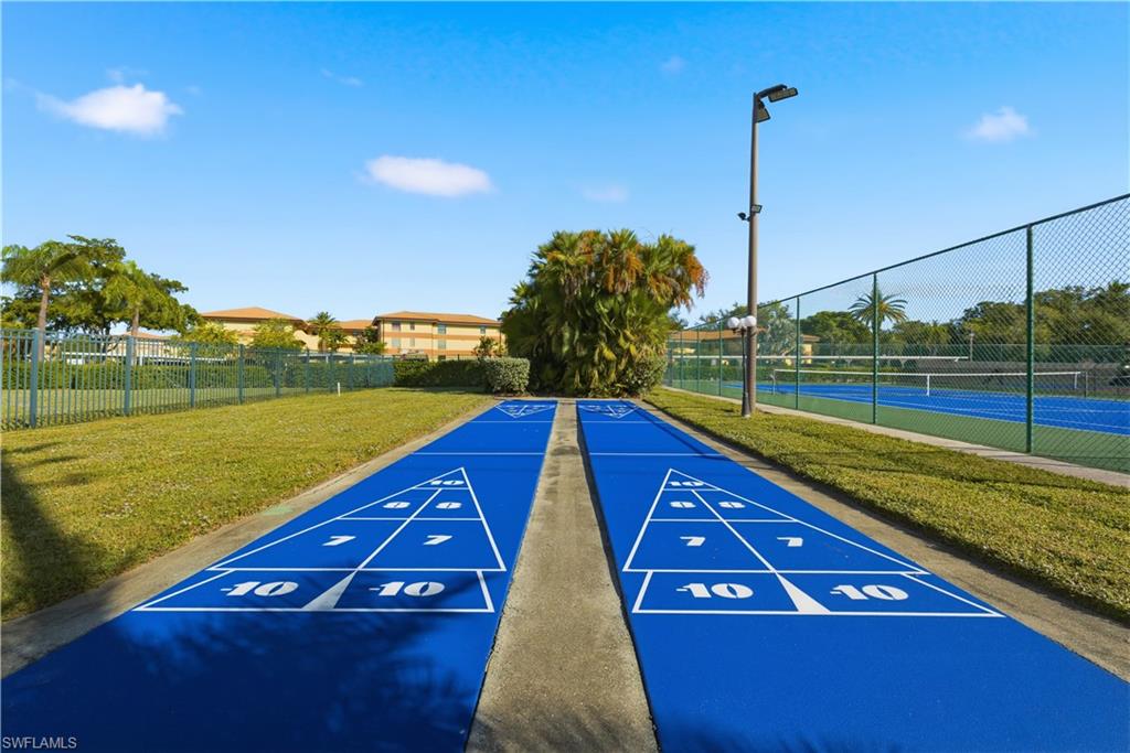 Dual shuffleboard courts featuring blue playing surfaces and white numerical markings