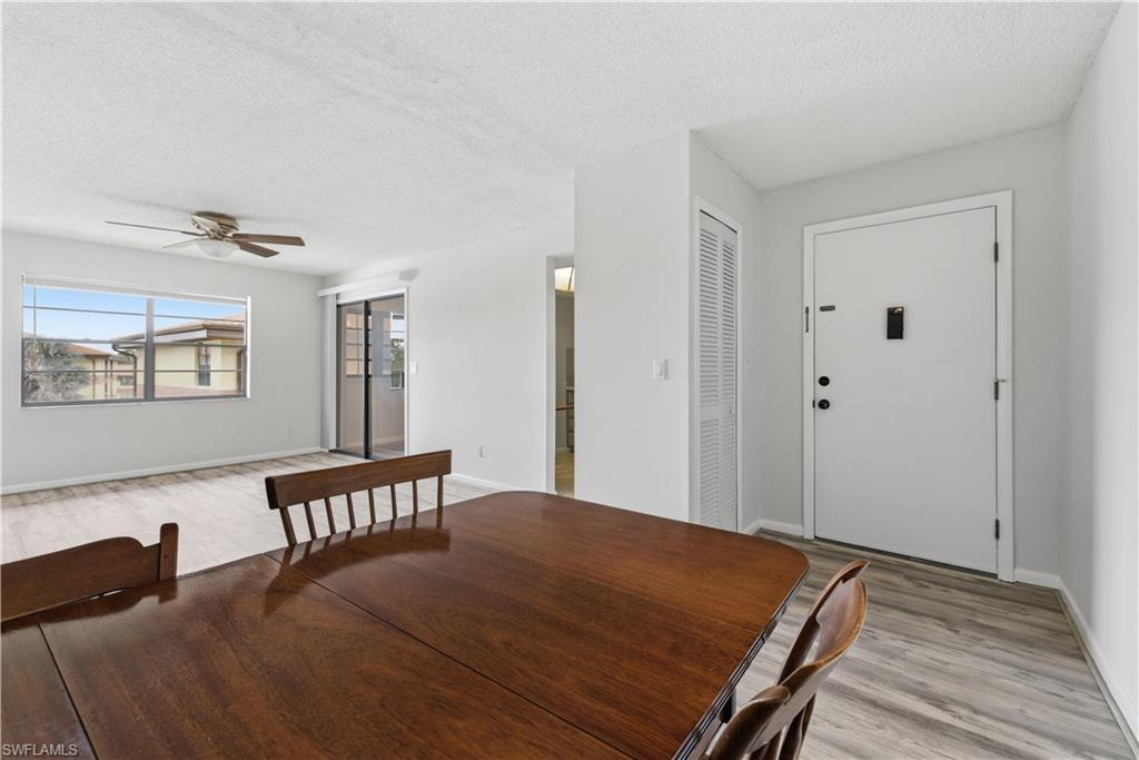 Open concept interior featuring light gray wall paint and wood-finish flooring
