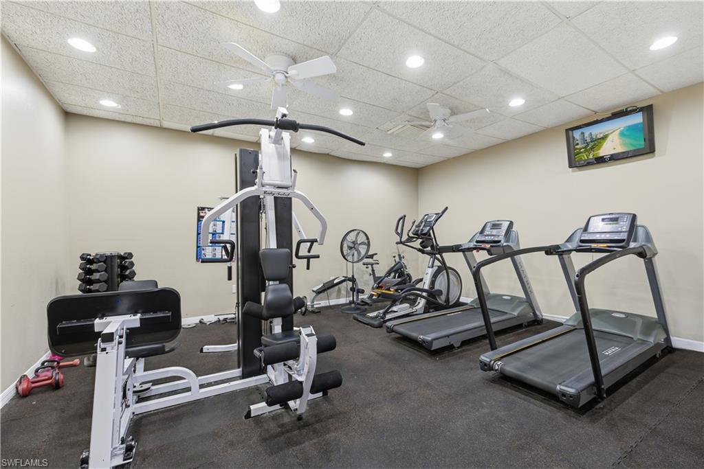 Dedicated fitness space featuring rubber flooring, recessed lighting, and dual ceiling fans