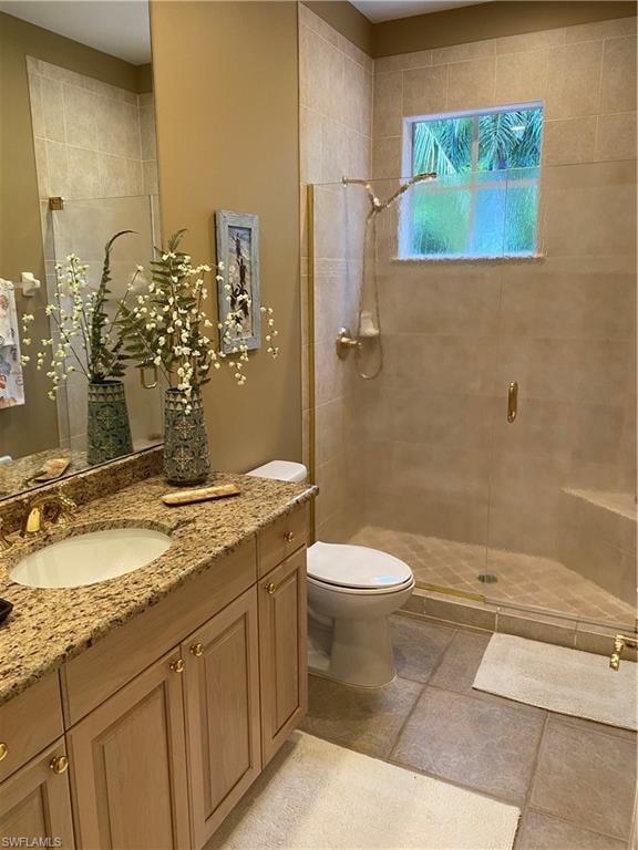 Full bath featuring a stall shower and vanity