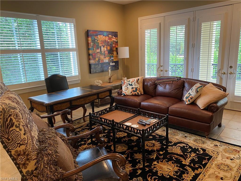 Living room featuring french doors, tile patterned flooring, and healthy amount of natural light